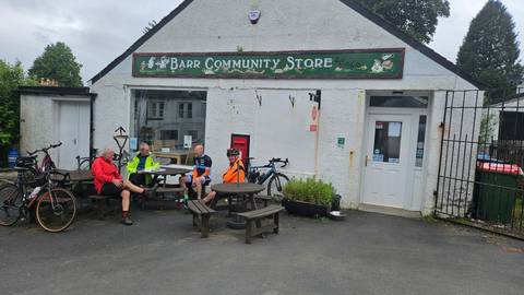 Cyclists sitting outside Barr Community Store and cafe.