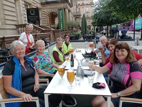 Female cyclists having drinks in Glasgow city centre.