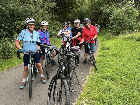 Female cyclists posing on a cycle path.