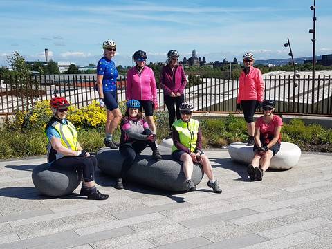 Cyclists posing on very large stones.