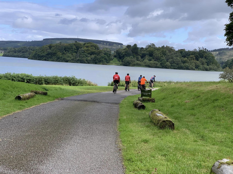 Cyclists approaching a loch